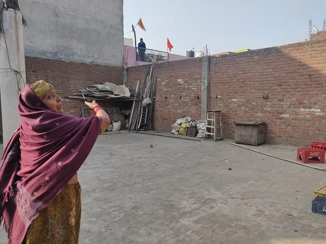 Uma Sharma shows the wall that the family jumped over to their safety on 24 February night 