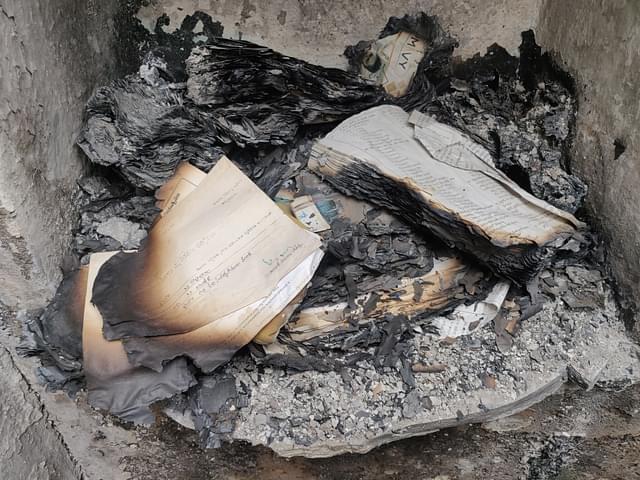 Burnt school books and certificates in Radhabai’s house.