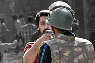 Delhi police head constable Deepak Dahiya and gun wielding riot accused Shahrukh Pathan.