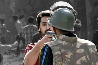 Delhi police head constable Deepak Dahiya and gun wielding riot accused Shahrukh Pathan