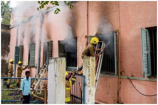 Firefighters attempt to douse fire