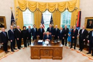 Trump with Senator Mitch McConnell and others during the signing of the bill (Pic Via Twitter)