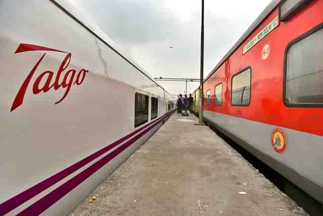 A high-speed Talgo Train stands on a platform next to a Rajdhani Express. (Raj K Raj/Hindustan Times via Getty Images)