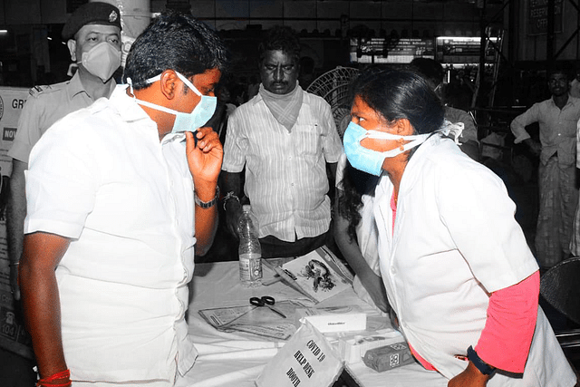 Tamil Nadu Health Minister Dr Vijaya Baskar, left, talking to officials at a Covid-19 testing centre.