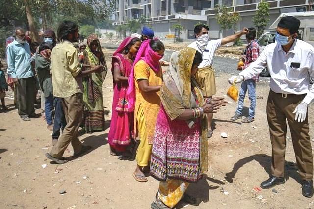 RSS volunteers distributing food packets.