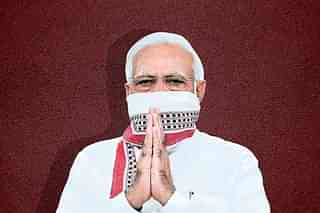 PM Modi covering his mouth with the gamcha, or the ‘humble towel’.