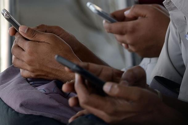 People using their mobile phones. (Photo credit: INDRANIL MUKHERJEE/AFP/Getty Images)