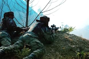 Indian soldiers look on from their position by a road overlooking army barracks.  (ROUF BHAT/AFP/GettyImages)