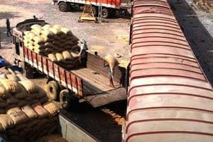 Gunny sacks being unloaded from an Indian Railways goods train.