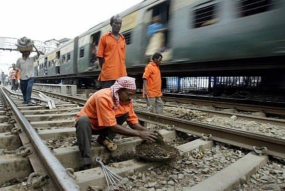 Indian railway workers perform track maintenance at a station in Kolkata. (DESHAKALYAN CHOWDHURY/AFP/Getty Images)