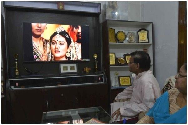A family watching Ramayan at home. 