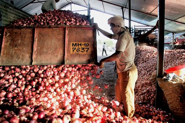 Onions being off-loaded at an agricultural produce yard.