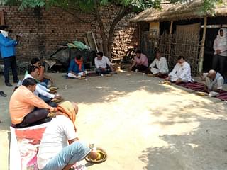 Vijay Dubey and his associates eating food prepared by the Dalit pradhan of Bhujouli Khurd village in Kushinagar, UP, on 10 April