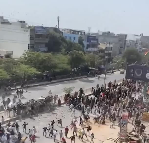 Police party gheraoed from all sides by rioters, led by women.