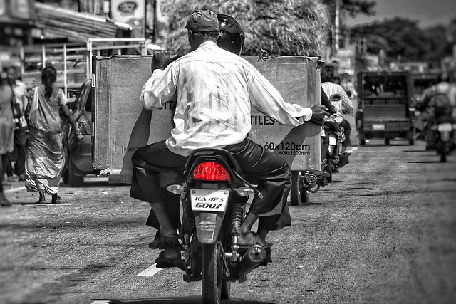 A man rides a two-wheeler.