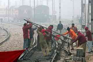 Indian Railways employees work on a railway track in New Delhi. (RAVEENDRAN/AFP/Getty Images)