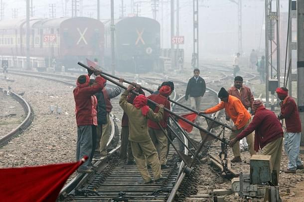 Indian Railways employees work on a railway track in New Delhi. (RAVEENDRAN/AFP/Getty Images)
