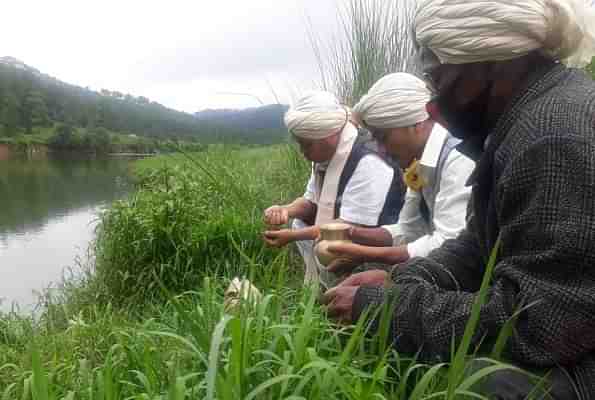 Tribe members collecting water from a local river in Nartiang for the Bhoomi Puja at Ayodhya.  