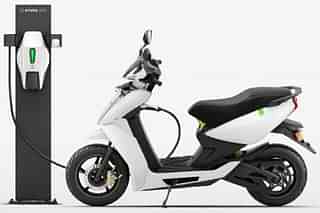 An electric scooter at a charging station.