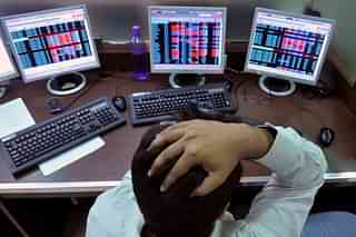 An Indian stockbroker reacts as he watches share prices on his computer at a brokerage firm in Mumbai. (INDRANIL MUKHERJEE/AFP/GettyImages)