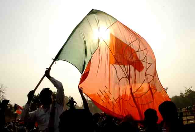 BJP support with party flag during election campaign rally. (Samir Jana/Hindustan Times via Getty Images)