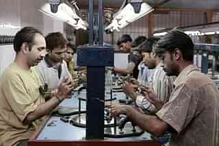 Workers busy polishing diamonds at a factory. (Satish Bate/Hindustan Times via Getty Images)