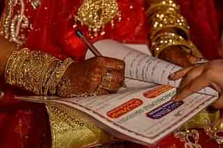 A woman signs a Nikah nama. Representative image. (Kunal Patil/Hindustan Times via Getty Images) 