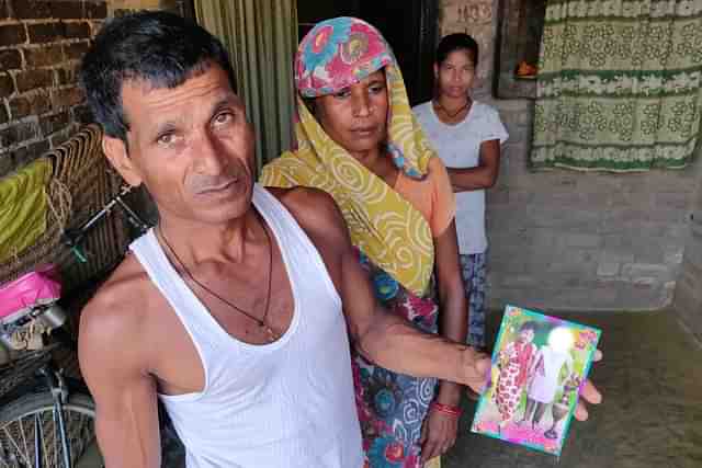 The victim’s father holds a photograph of his daughter. Picture clicked on 4 October