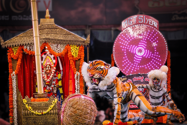 Tigers lifting the rice ‘mudi’ symbolically in front of Mangaladevi.