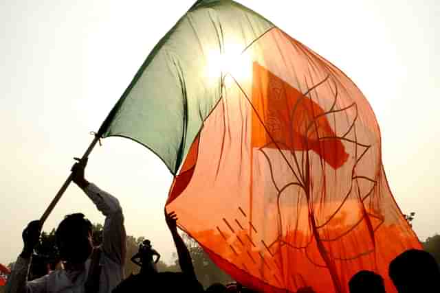 BJP support with party flag during election campaign rally. (Samir Jana/Hindustan Times via Getty Images)