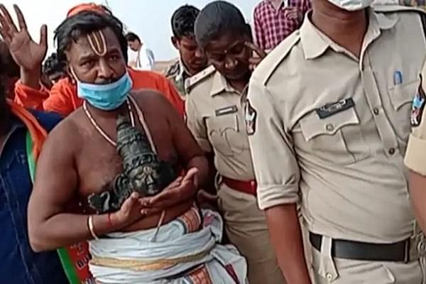 Temple priest with part of desecrated idol  (India Today)