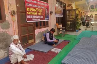 Nikita Tomar’s father Moolchand Tomar (in black) at his house after her murder on 26 October. (Swarajya) 