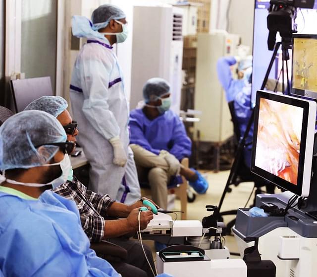 Surgical team performs a robot-assisted procedure.