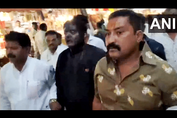BJP leader in the centre with his face blackened (ANI)