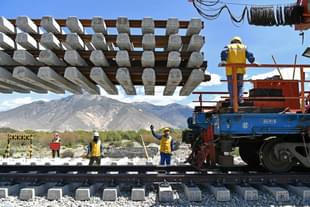 Workers deliver new railroad ties for Sichuan-Tibet railway in Dranang, the Tibet autonomous region, in June. (Xinhua)  