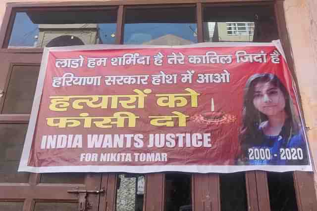 A banner outside Nikita Tomar’s house in November 2020.