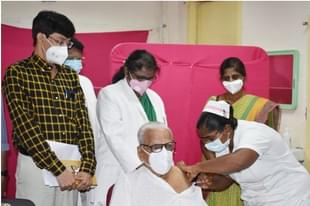 Dr Hande taking a  second dose of the Covid vaccine as Health Secretary Dr J Radhakrishnan looks on.