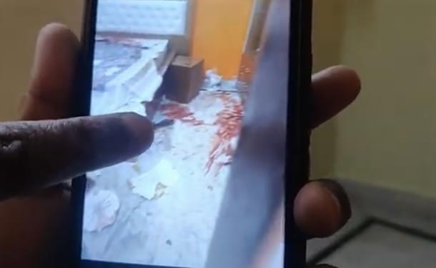 A relative of Mahesh shows a picture of the room after the bodies were taken away on 6 February