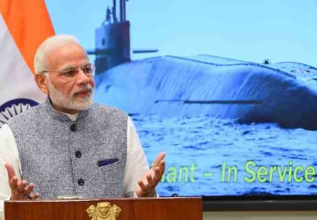 Prime Minister Narendra Modi speaking at an event with an image of INS Arihant, its clearest pictures, in the background. (@narendramodi/Twitter)