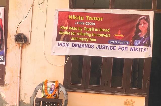 A banner outside Nikita Tomar’s house a week after her murder