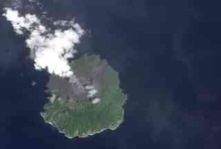 A plume of ash rises from Barren Island Volcano on 25 September 2010. (NASA)
