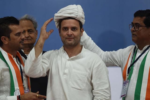 Congress workers present a turban to Rahul Gandhi during a public meeting at Varachha Surat, on 3 November in Gujarat, India. (Vijayanand Gupta/Hindustan Times via GettyImages)