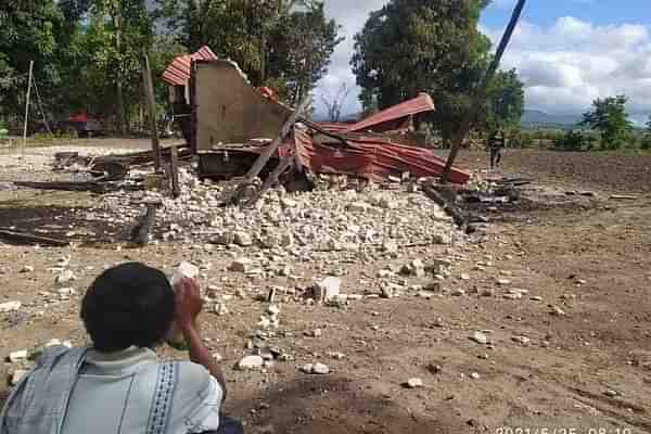 A villager looks on in Myanmar, as the military junta bombs public dwellings and kills thousands, as part of a coup. 