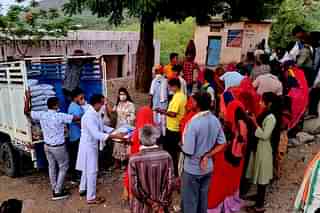 BJP party workers in Rajasthan helping families with ration in villages.