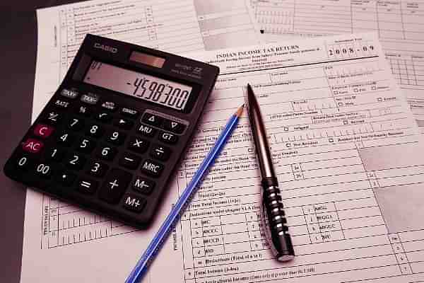 A representative image of Indian income tax return form with calculator and a pen. (Rajkumar/Mint via Getty Images)