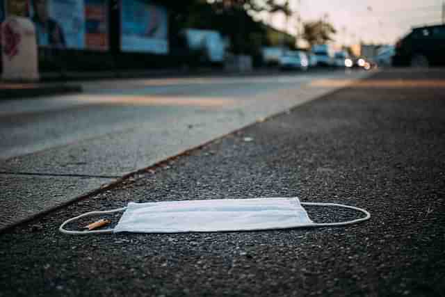 A mask lying on a street.