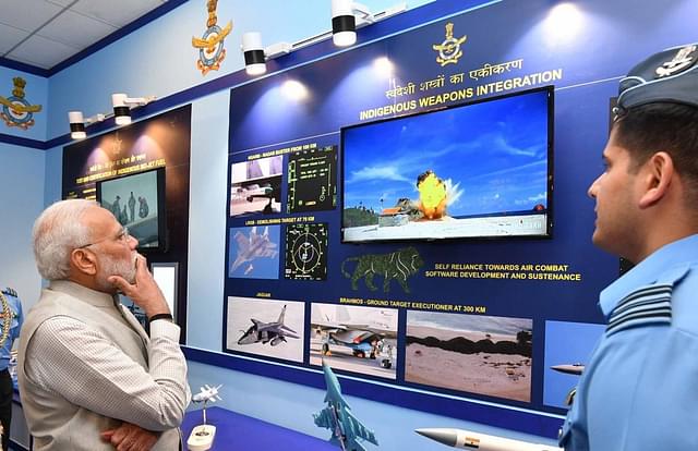 Prime Minister Narendra Modi watching a video of a BrahMos missile impact.