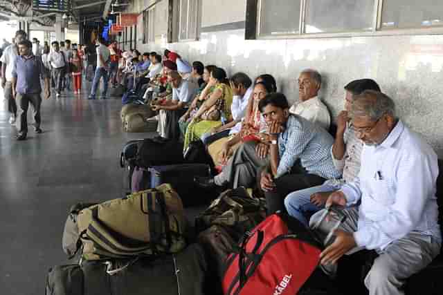 Passengers sitting on the platform at New Delhi Railway Station (onu Mehta/Hindustan Times via Getty Images)