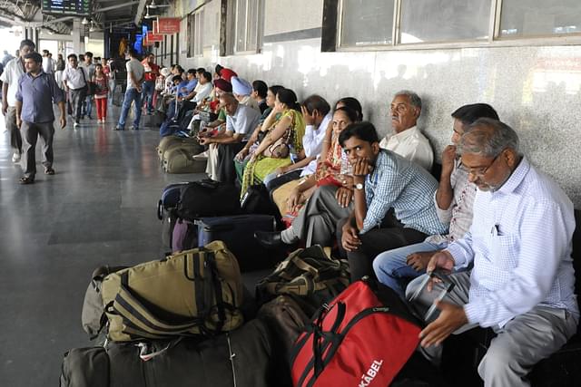 Passengers sitting on the platform at New Delhi Railway Station (onu Mehta/HT/Getty Images)