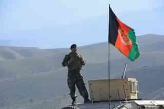 Afghan soldier standing on an armoured personnel carrier.